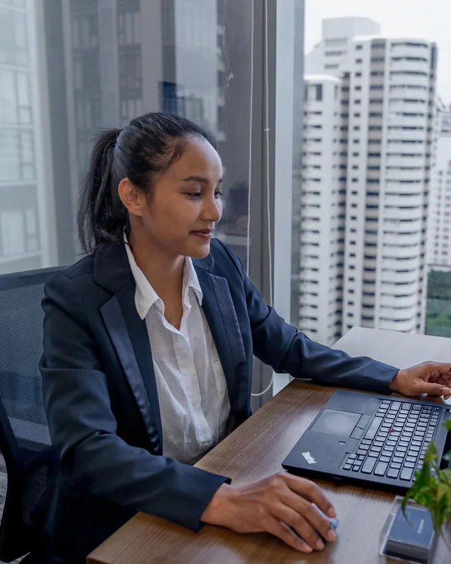 Yupin Numyen working at her desk in the Bangkok office